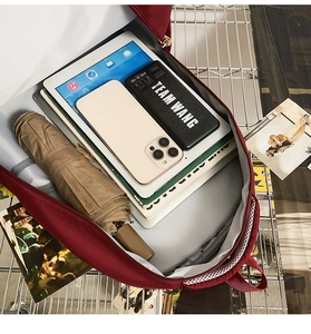 Detail showing high-capacity main compartment of red backpack with multi-pocket storage