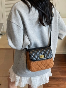 Retro quilted patchwork shoulder bag with gold twist lock worn by a model in a casual setting