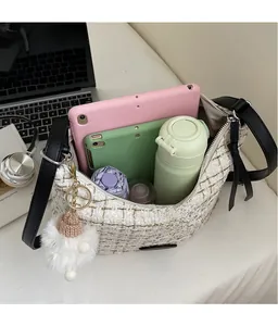 Detail view of large white tweed tote bag showing spacious interior with tablet and items
