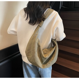 Detailed look at the khaki canvas dumpling bag showing its natural texture and large capacity