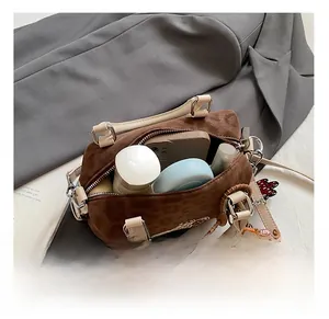 Detail showing internal capacity of leopard print boston bag with phone and cosmetics