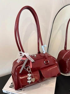 Minimalist burgundy bowling shoulder bag with heart charms and ribbon details