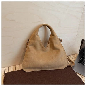 Detailed texture of camel matte suede material on minimal crossbody dumpling bag