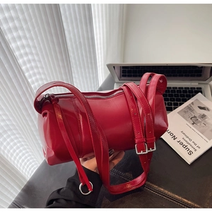 Detail der roten Zylindertasche aus glänzendem Lackleder mit verstellbaren Riemen