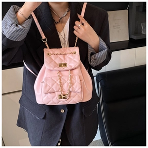 Detail of pink quilted PU leather mini backpack with gold twist lock and chain strap