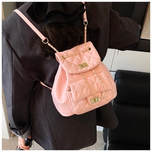 Detailed view of pink quilted PU leather backpack with gold clasp and chain strap