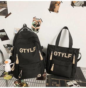 Detail of black nylon backpack and tote bag set with GTYLF logo and cartoon duck charm