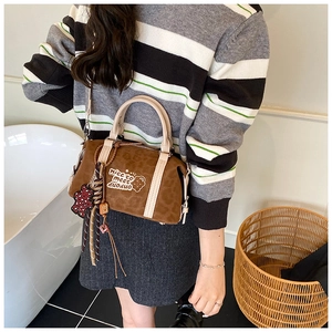 Details der Handtasche mit Leopardenmuster, Plüschbär-Anhänger und Stickerei im Lifestyle-Stil