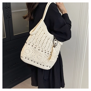 Detail of bohemian ivory crochet tote bag with fringe wood beads and woven floral patterns