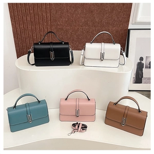 Variety set of stylish women's PU leather handbags in five colors on a display stand