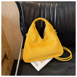 Detailed macro shot of yellow frosted leather handbag with V-shaped opening and long strap