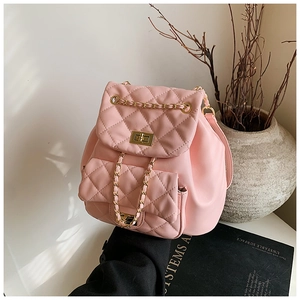 Detail of pink quilted leather mini backpack featuring gold turn-lock and chain drawstring
