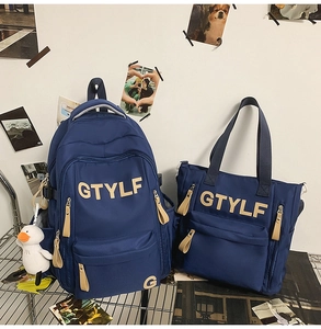 Detail of dark blue nylon backpack set with white duck pendant on silver metal shelf