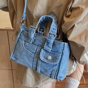 Classic washed blue denim tote bag with vintage metal buttons and belt strap detail