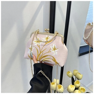 Detail of pink cheongsam bag with lily flower embroidery and gold chain strap