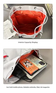 Detail of the gray canvas backpack with orange lining showing large interior capacity