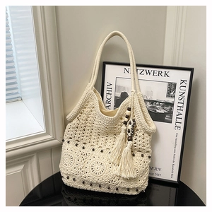 Detail of hand-woven tote bag showing floral crochet patterns and decorative wooden beads