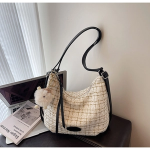 Chic off-white tweed hobo bag with black leather strap and a cute sheep keychain