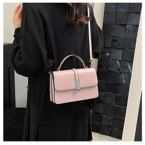 Detail of pink PU leather handbag showing a silver rectangular flip lock and top handle