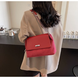 Detailed close-up of dark red vintage chain bag with silver ROBER metal logo plaque