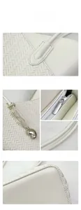 Macro view of white woven leather texture with cylindrical handle and silver pendant detail
