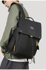 Detail of canvas travel backpack with yellow contrast zippers and side pocket feature