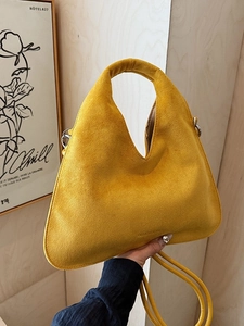 Fashionable bright yellow suede dumpling bag with V-shaped opening and crossbody strap