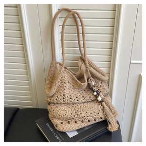 Detail of hand-woven crochet tote bag featuring wooden beads and long tassels