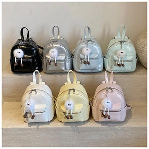 Detailed collection of mini backpacks in seven vibrant colors with cute plush pendants