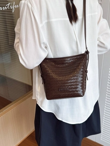 Dark brown woven texture bucket bag with adjustable strap and metallic logo detail