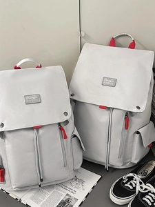 Large grey canvas backpack with red accents for travel and student daily use