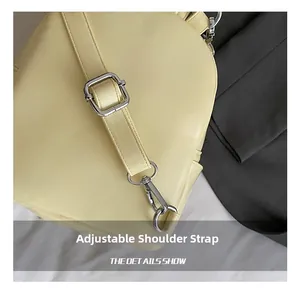 Detail view of the mini backpack showing adjustable shoulder strap with silver hardware