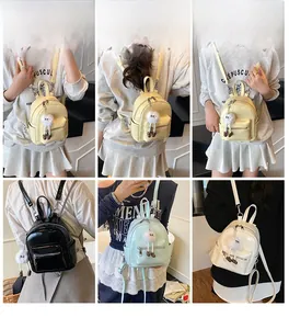 Mini PU backpack detail showing soft yellow, black, blue, and white colors with plush charm
