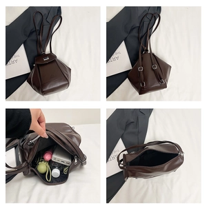 Detail view of dark brown geometric backpack showing internal storage and multi-way straps