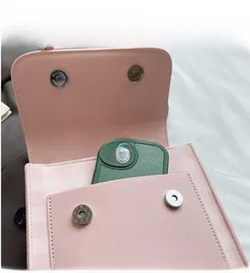 Internal view of pink crossbody bag showing spacious interior with a smartphone
