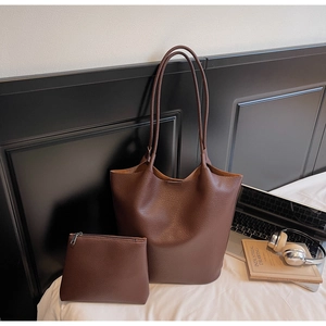 Close-up of brown lychee pattern leather tote bag with matching zipper pouch set