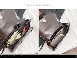 Detailed interior of the dark brown leather shoulder bag showing the main compartment