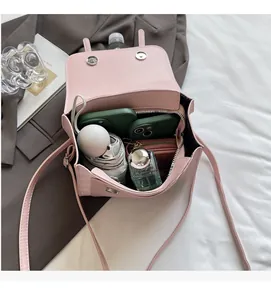 Detail view of pink bow backpack interior showing space for phone, umbrella and perfume