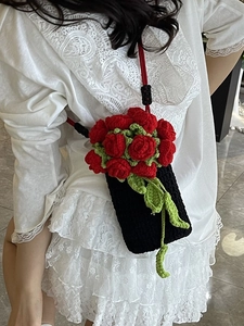 Handmade crochet mini crossbody bag with 3D red roses and green leaves on black knit