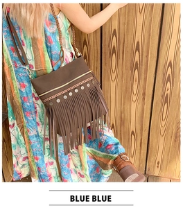 Detail of bohemian fringe crossbody bag with ethnic embroidery and metal sequins