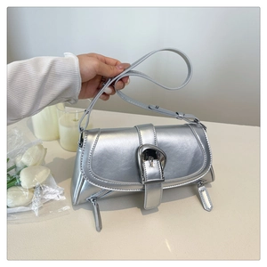 Detailed view of silver PU leather handbag with metallic buckle and dual zipper accents