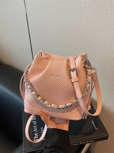 Pink knit textured bucket bag with silver chain strap and drawstring closure