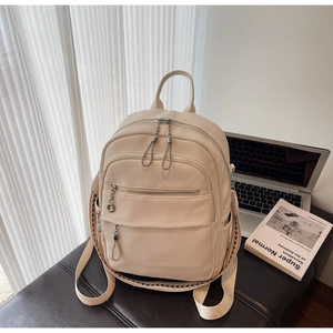 Detail of off-white PU leather backpack with lychee texture and woven geometric straps