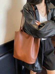 Large caramel brown leather tote bag with lychee texture and slim shoulder straps