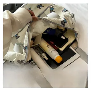 Detailed internal storage of white bubble texture bag with cute blue cartoon animal print