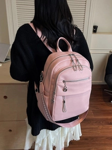 Pink faux leather backpack with litchi texture and stylish wave-stitched shoulder straps