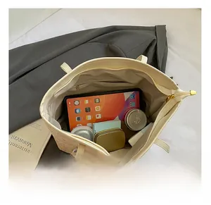 Internal view of the cream white tote bag showing spacious compartments and storage capacity