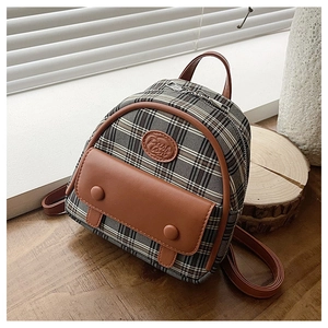 Detail of vintage plaid mini backpack with brown leather flap and Fashion embossed logo