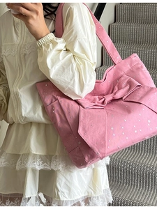 Pink canvas tote bag featuring a large bow and silver star print for casual fashion