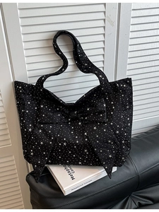 Large black star print canvas tote bag featuring a decorative bow and shoulder straps